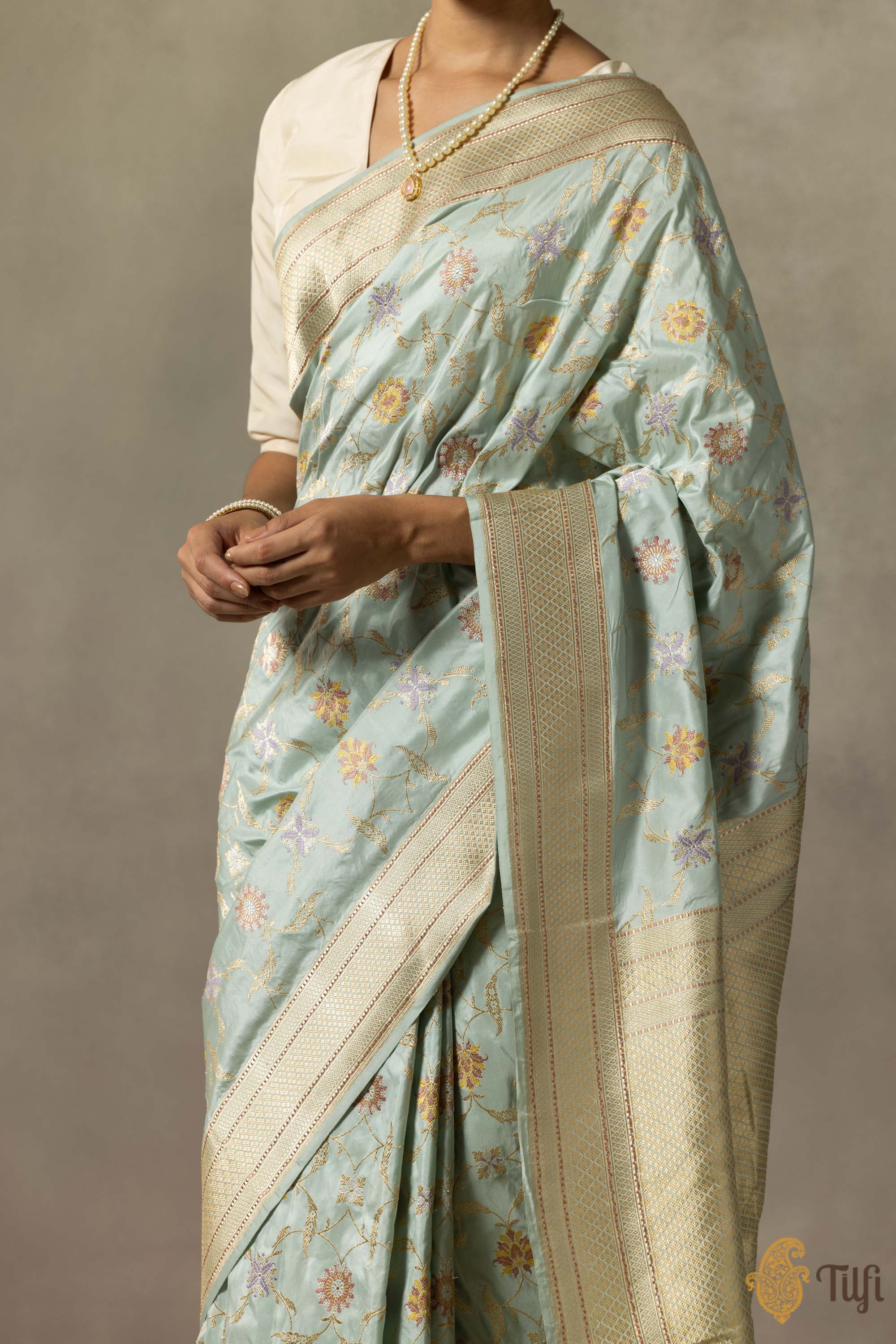 Front view of the light powder blue Katan silk saree with detailed Meenakari design.