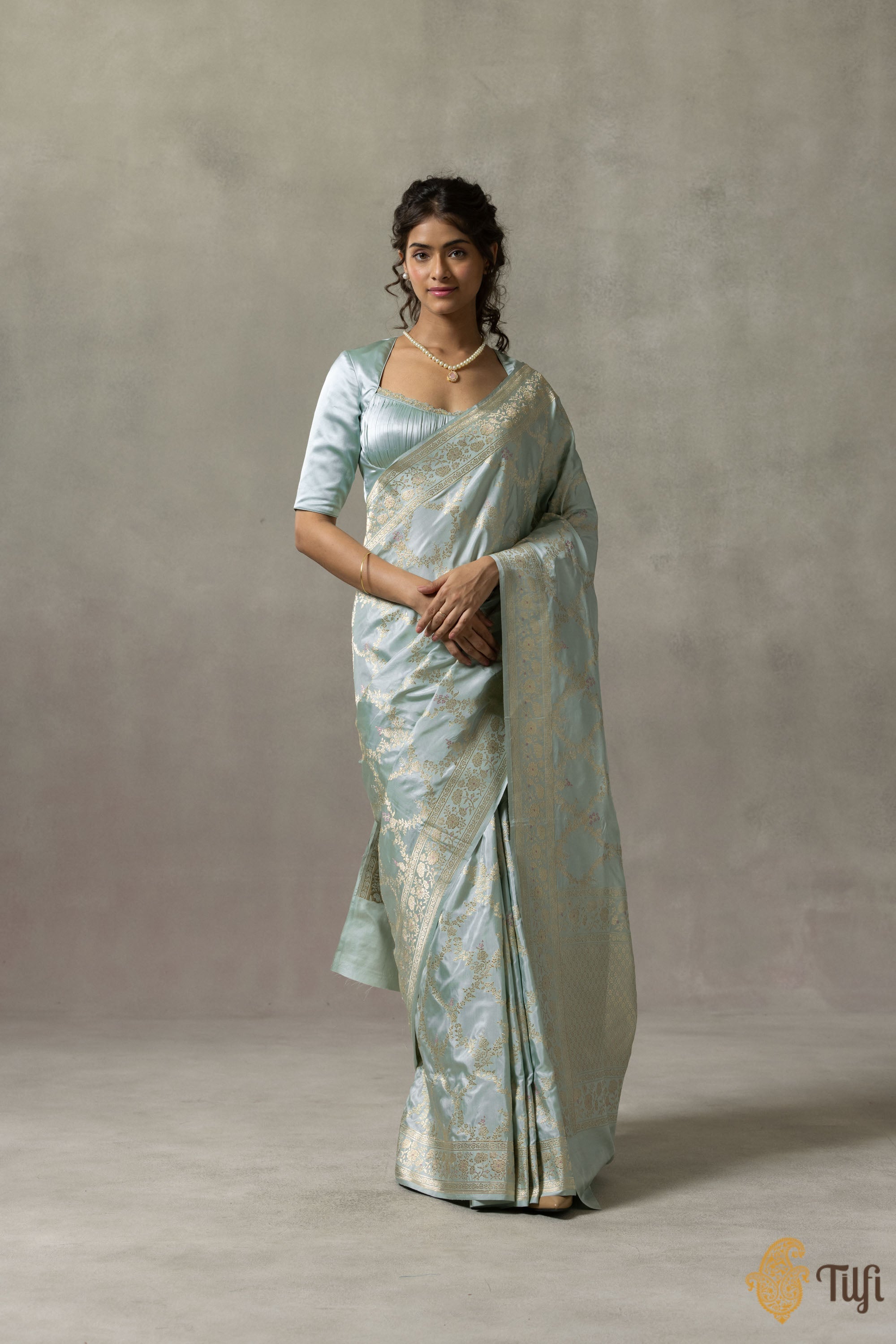 Elegant light blue Katan silk Banarasi handloom saree draped elegantly with intricate zari work.