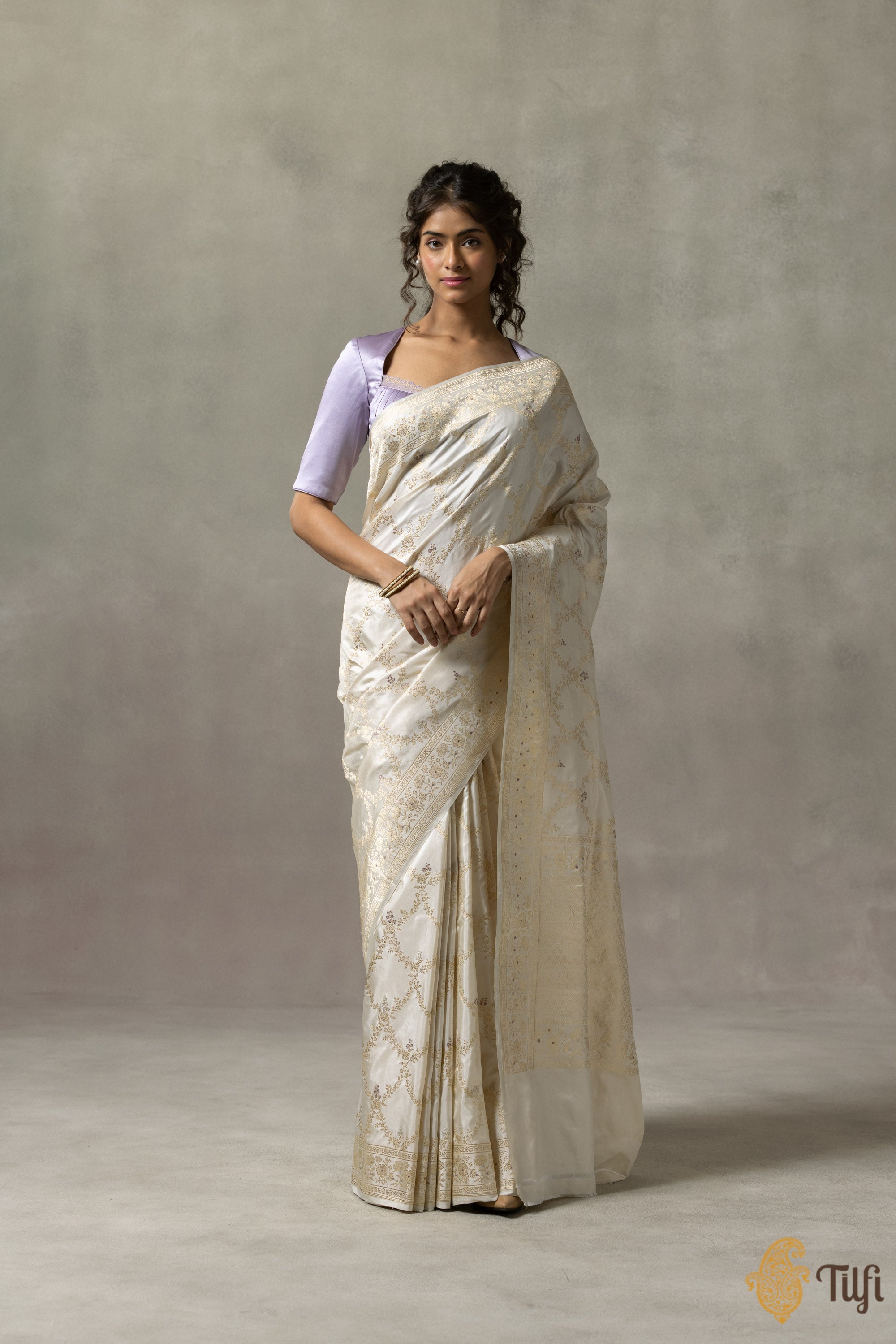 Close-up of the ornate zari trellis pattern on the Banarasi saree