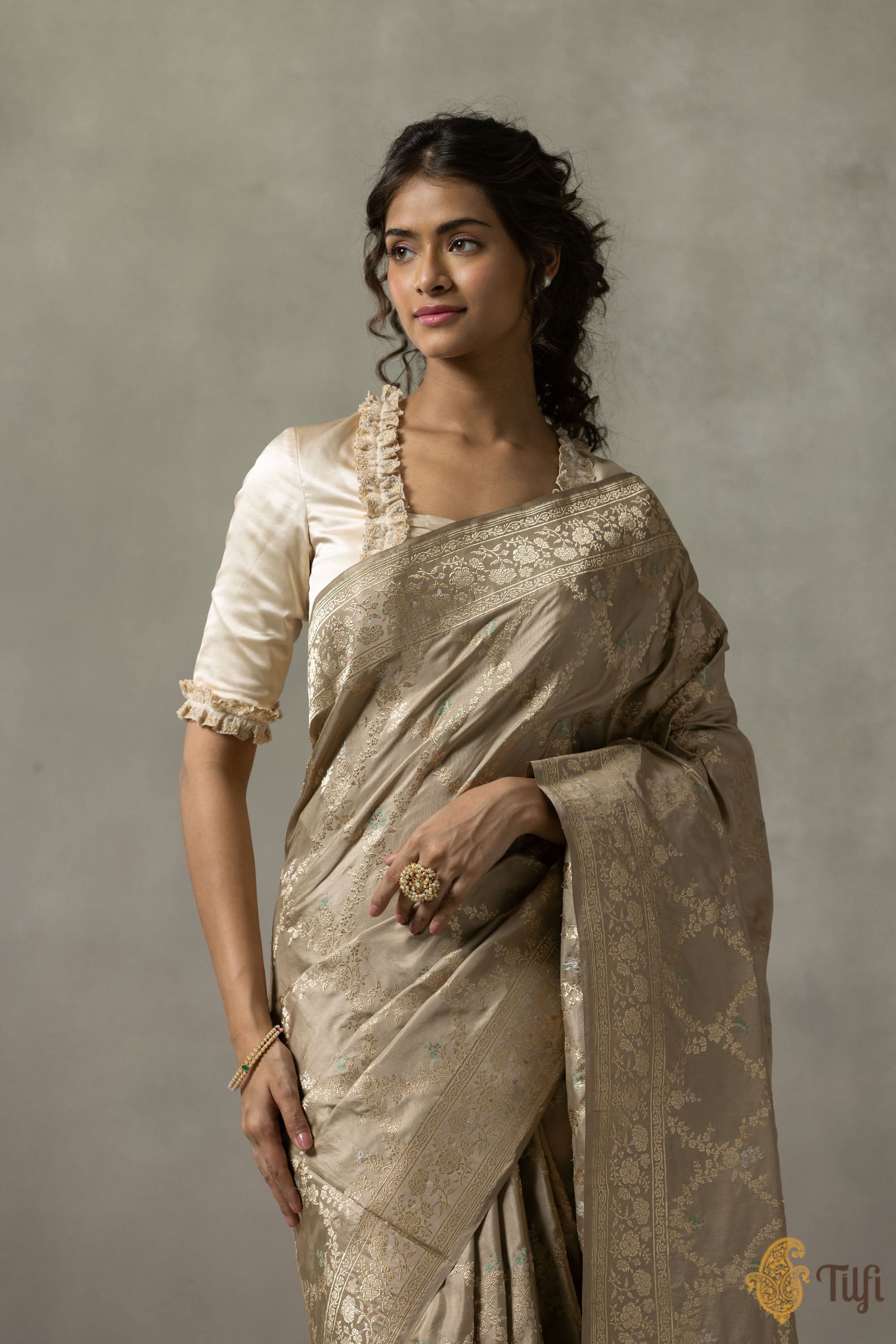 Close-up of the Tan Beige Katan Silk Banarasi Handloom Saree displaying exquisite zari work and floral details.