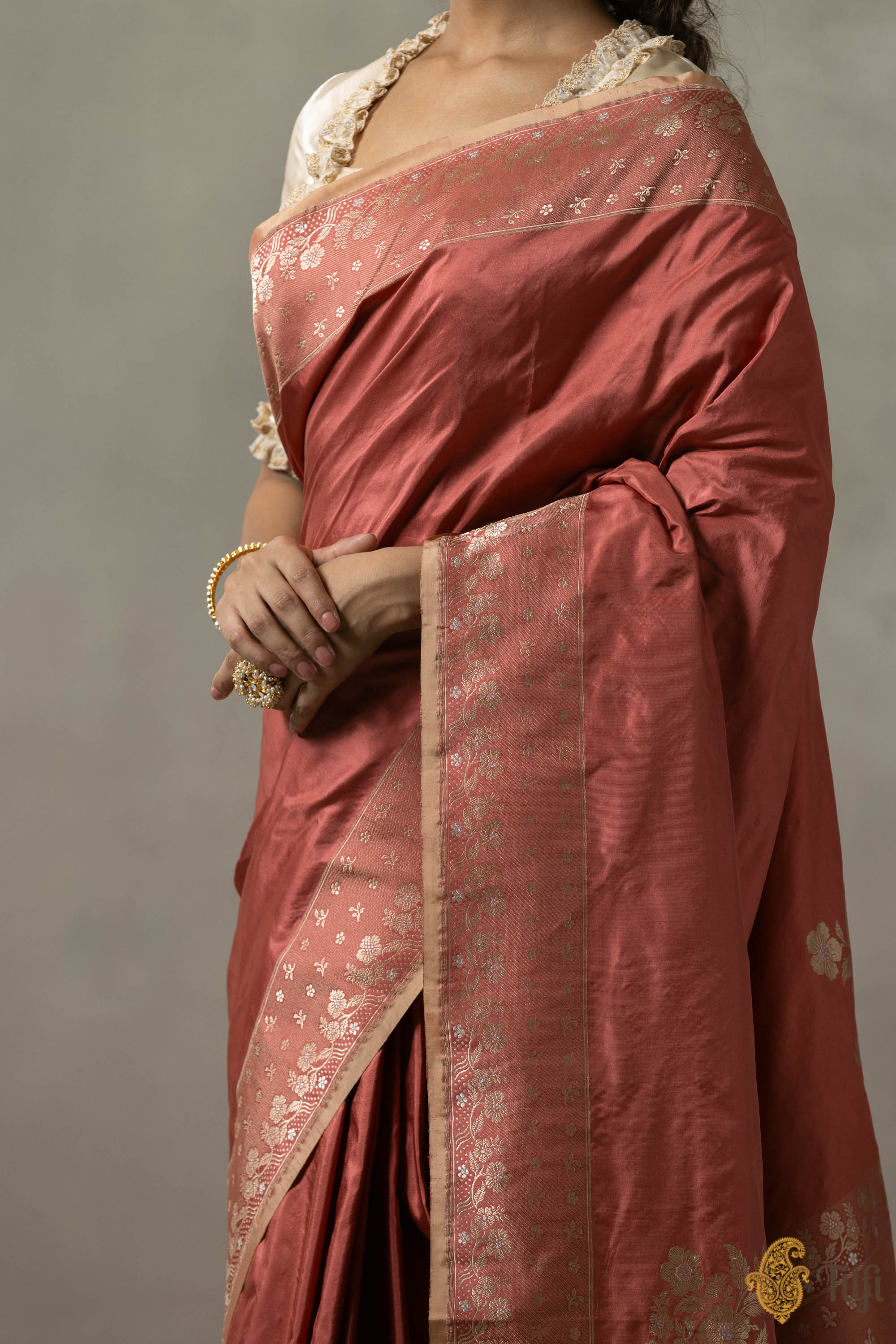 Front view of dusty rose Banarasi saree with Rococo-inspired zari border, styled with minimal jewelry
