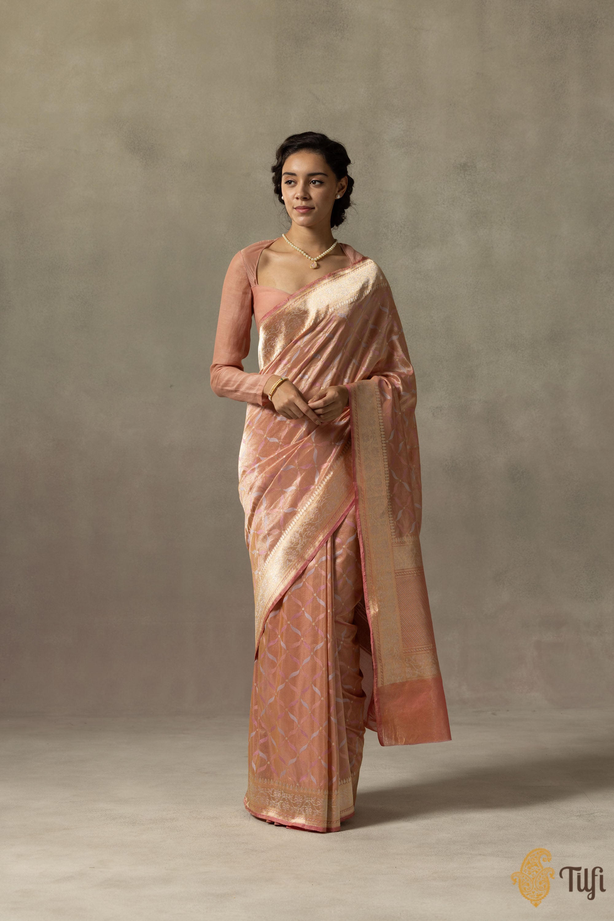 Close-up of the handcrafted Banarasi saree with intricate jaal and zari border