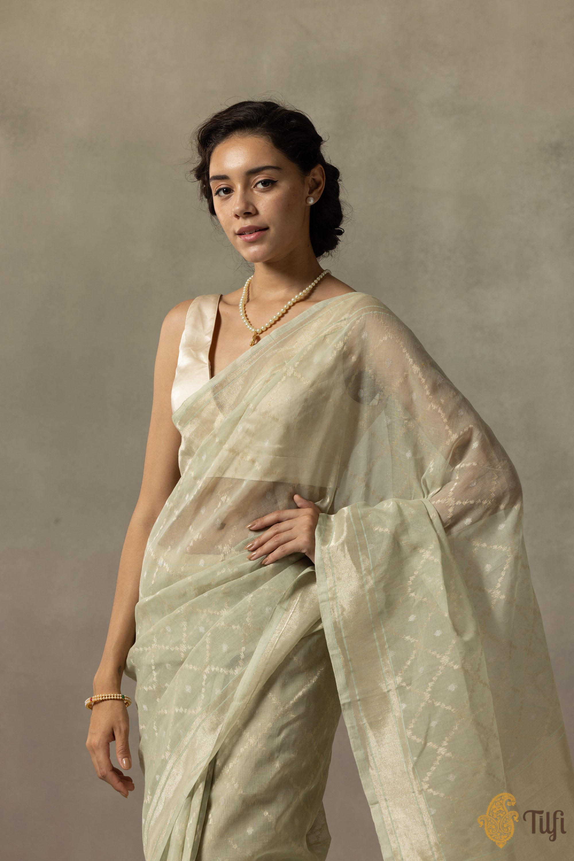 Close-up of intricate silver zari on handloom saree with Jamdani pattern