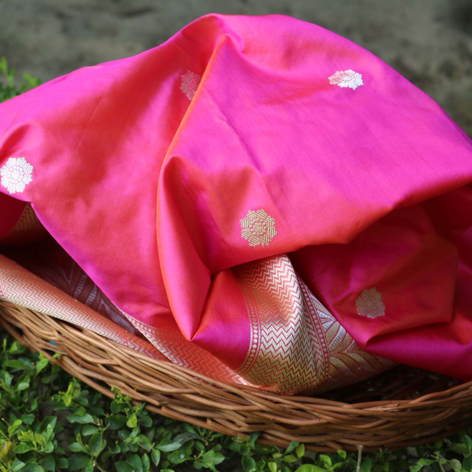 Vibrant pink-orange Banarasi dupatta with kadwa motifs showcasing handwoven craftsmanship