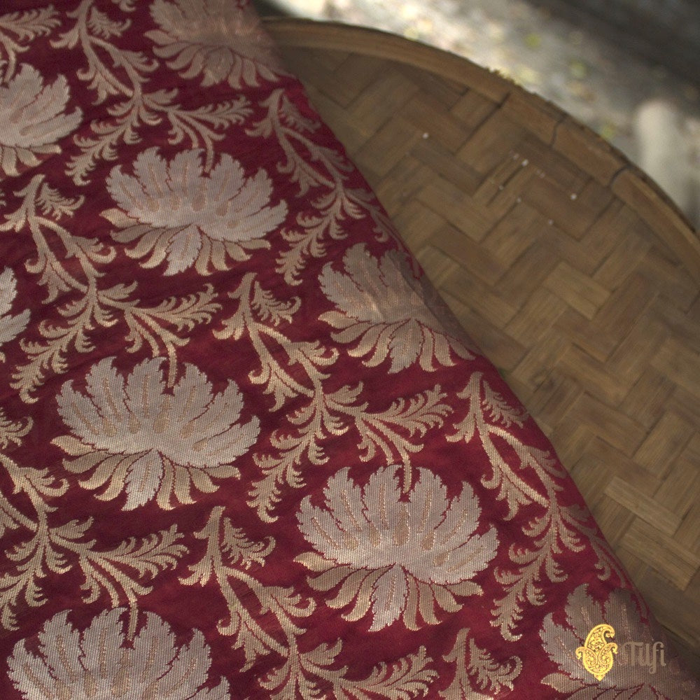 Detailed view of maroon Banarasi fabric with zari embroidery for sarees
