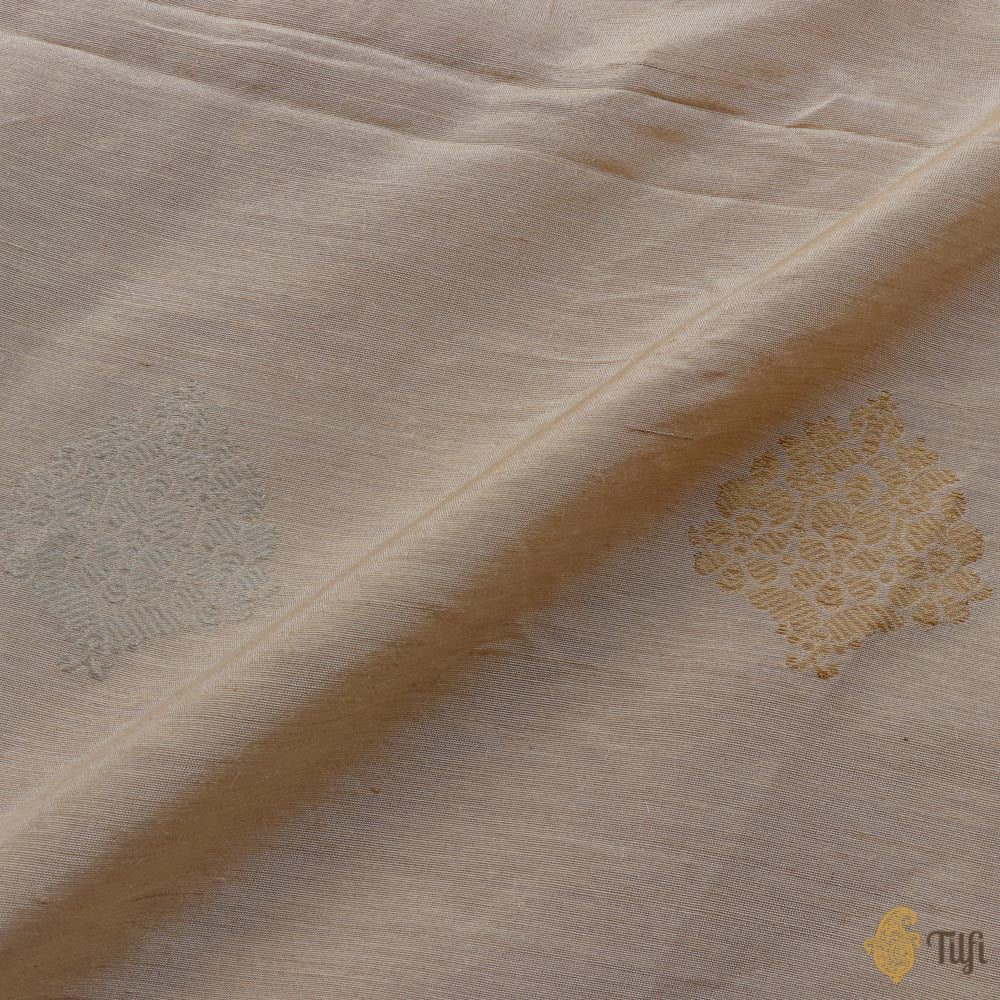 Elegant off-white Monga silk Banarasi handloom fabric with detailed floral motifs.